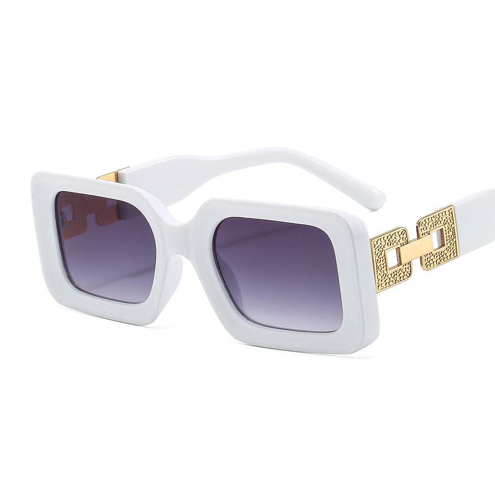 White sunglasses with gold accents on a white background