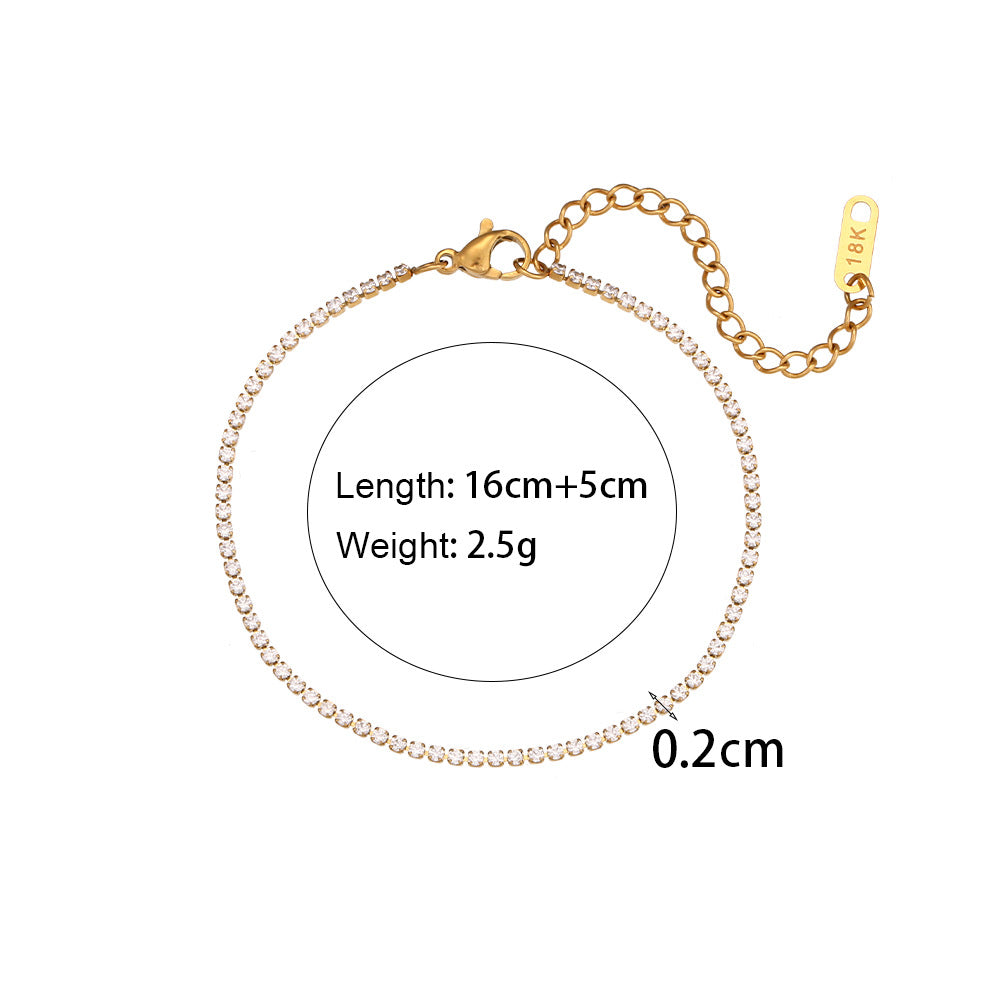 Gold tennis necklace with measurement details on a white background