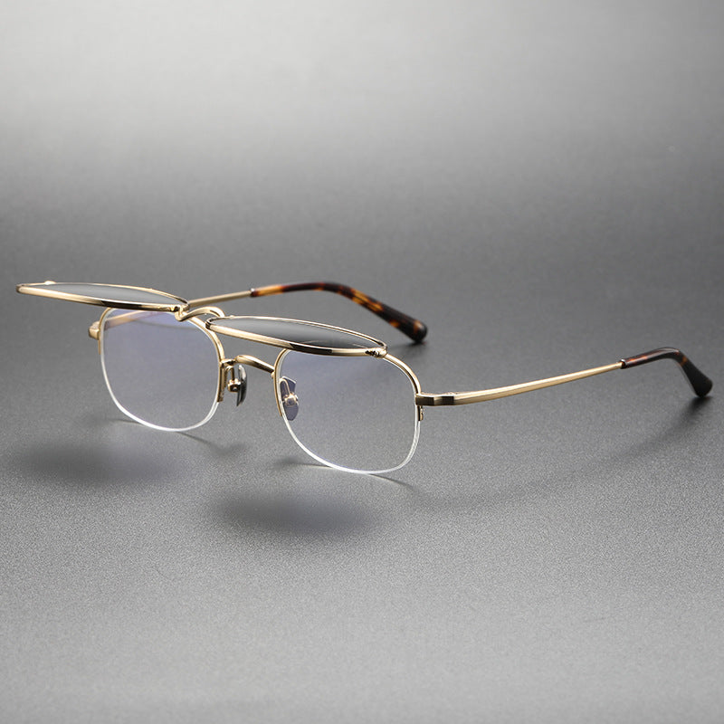 Gold-framed eyeglasses on a gray background