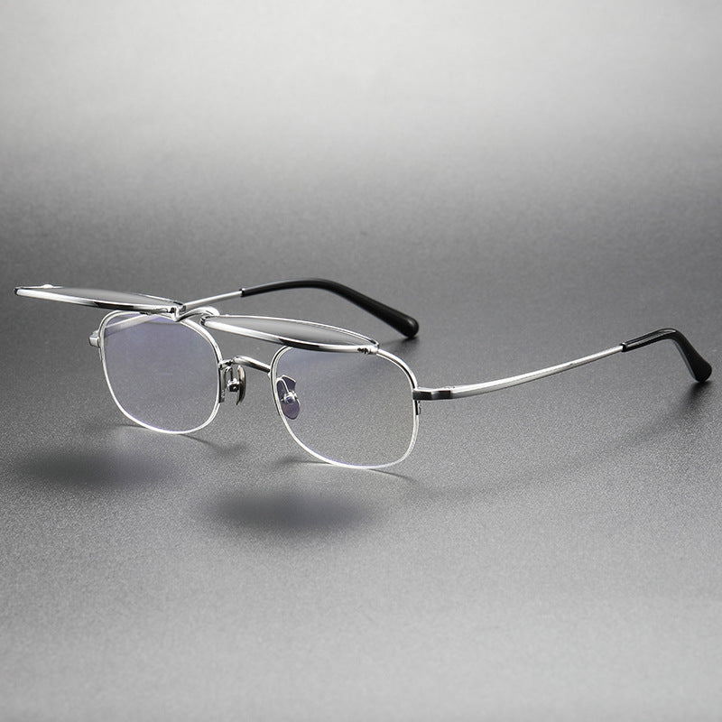 Silver-rimmed eyeglasses on a gray background