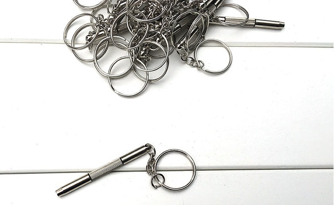 Collection of metal keychains on a white surface