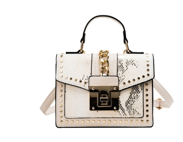 White women's crossbody alligator bag with gold chain and studded details
