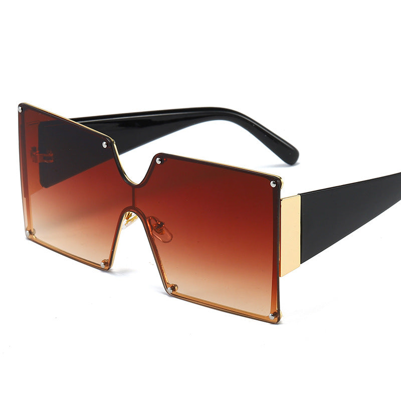 Sunglasses with a gradient brown lens and black frame on a white background