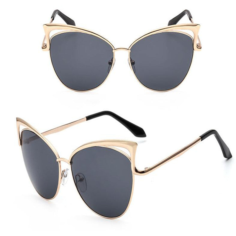 Gold-framed sunglasses with dark lenses on a white background