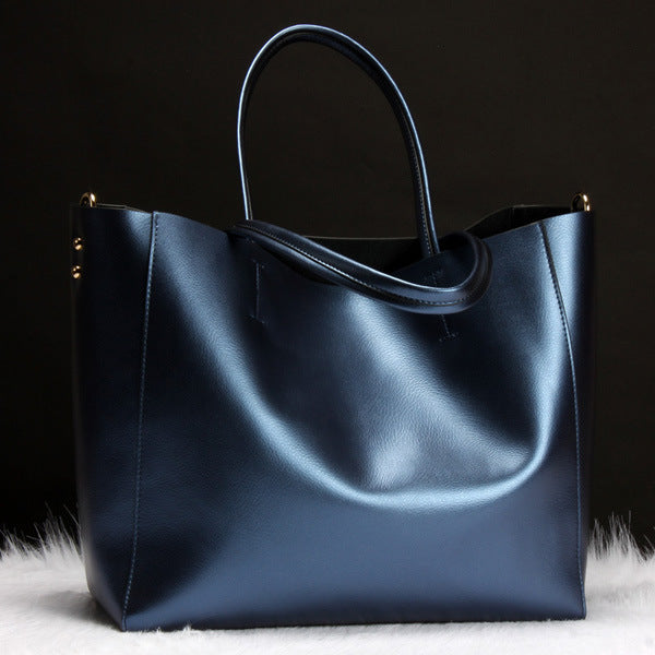 Blue leather handbag on a black background