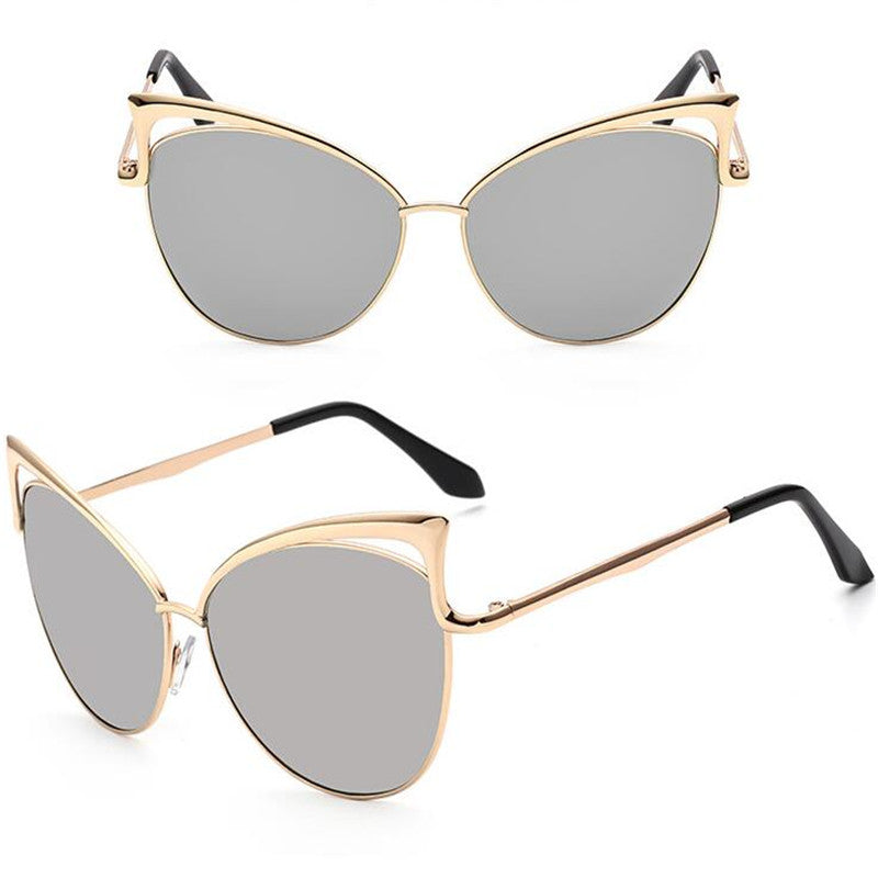 Gold-framed cat-eye sunglasses with silver lenses on a white background