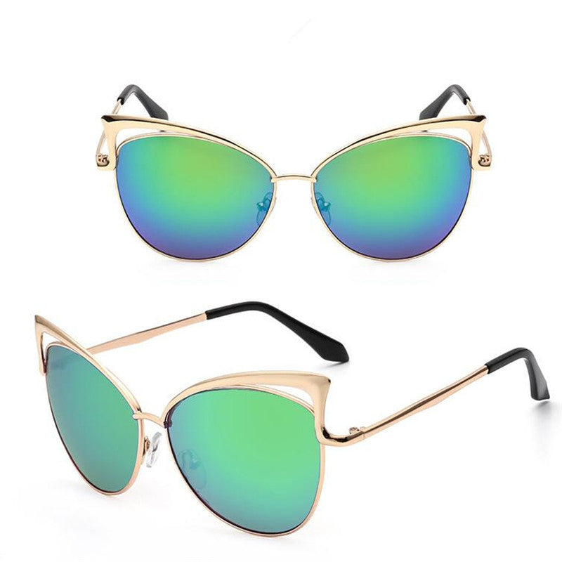 Cat-eye sunglasses with gold frames and green mirrored lenses on a white background