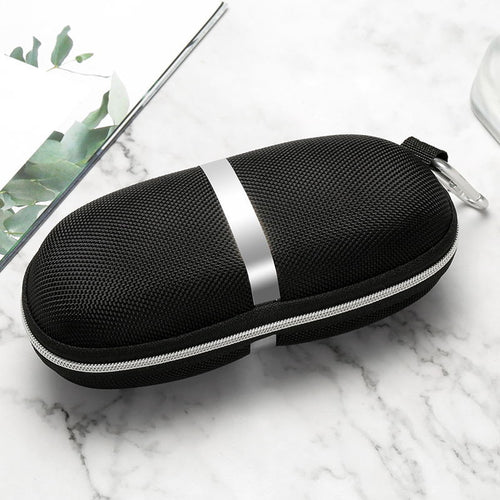 Black and silver zippered case on a marble surface with green leaves in the corner