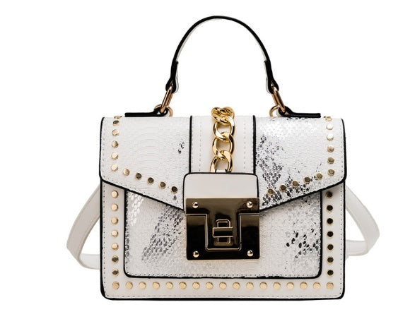 White women's crossbody alligator bag with gold accents