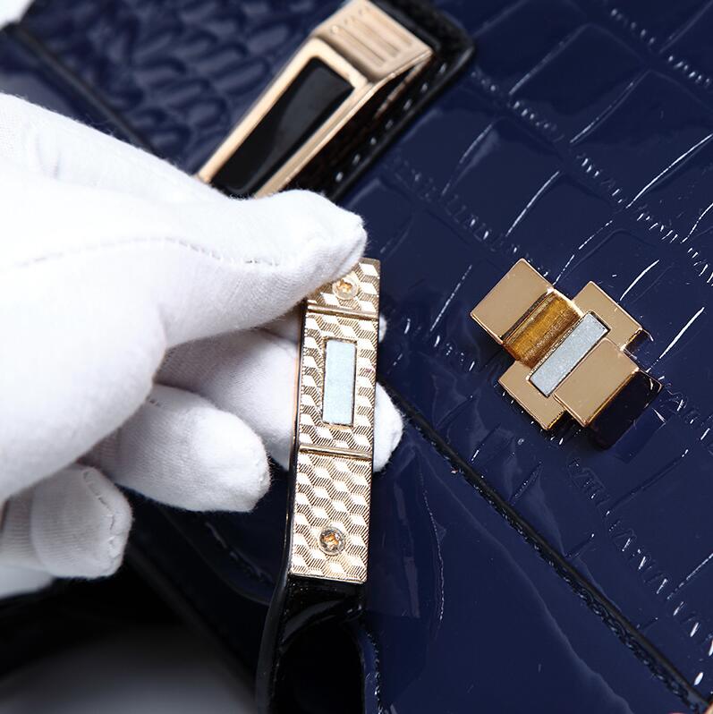Close-up of a navy blue crocodile pattern handbag