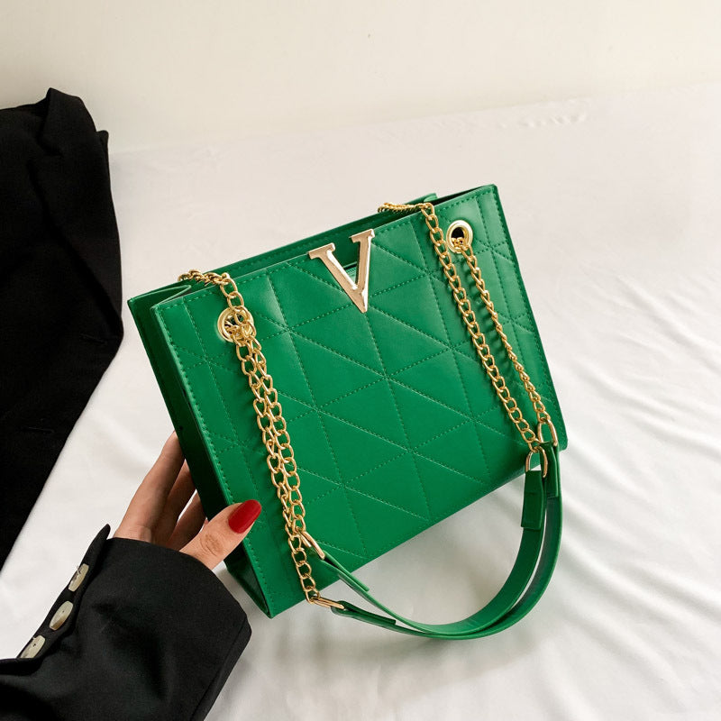 Green women's leather crossbody bag with gold chain and 'V' logo