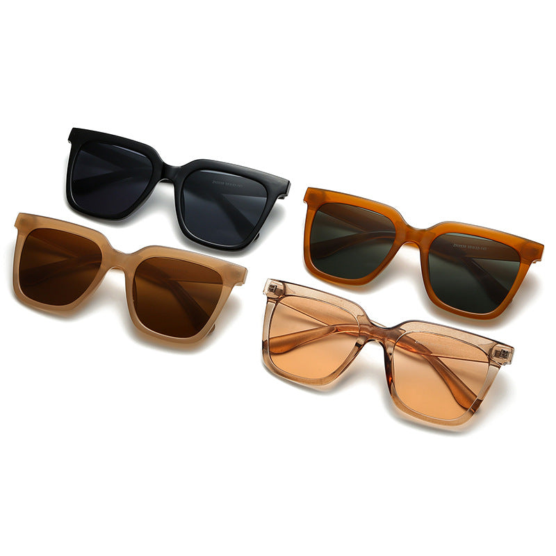 Four pairs of sunglasses with different frame colors and lens shades on a white background.