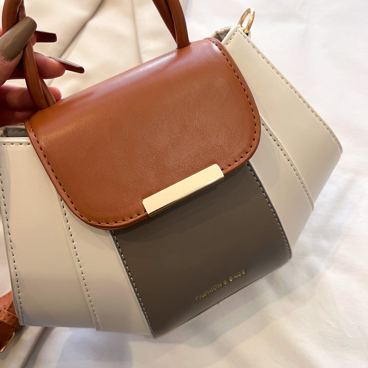 Multicolored women's handbag with brown, beige, and gray sections