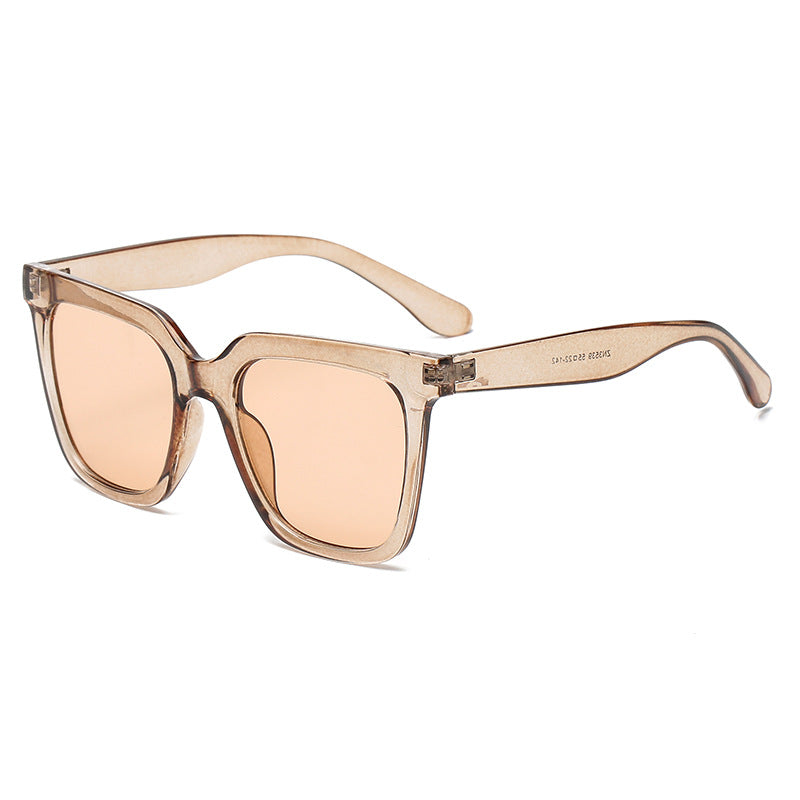 Beige sunglasses with a clear frame on a white background