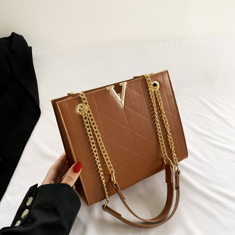 Brown women's leather crossbody bag with gold chain