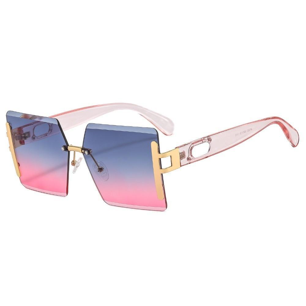 Sunglasses with gradient pink to blue lenses and gold frame on a white background