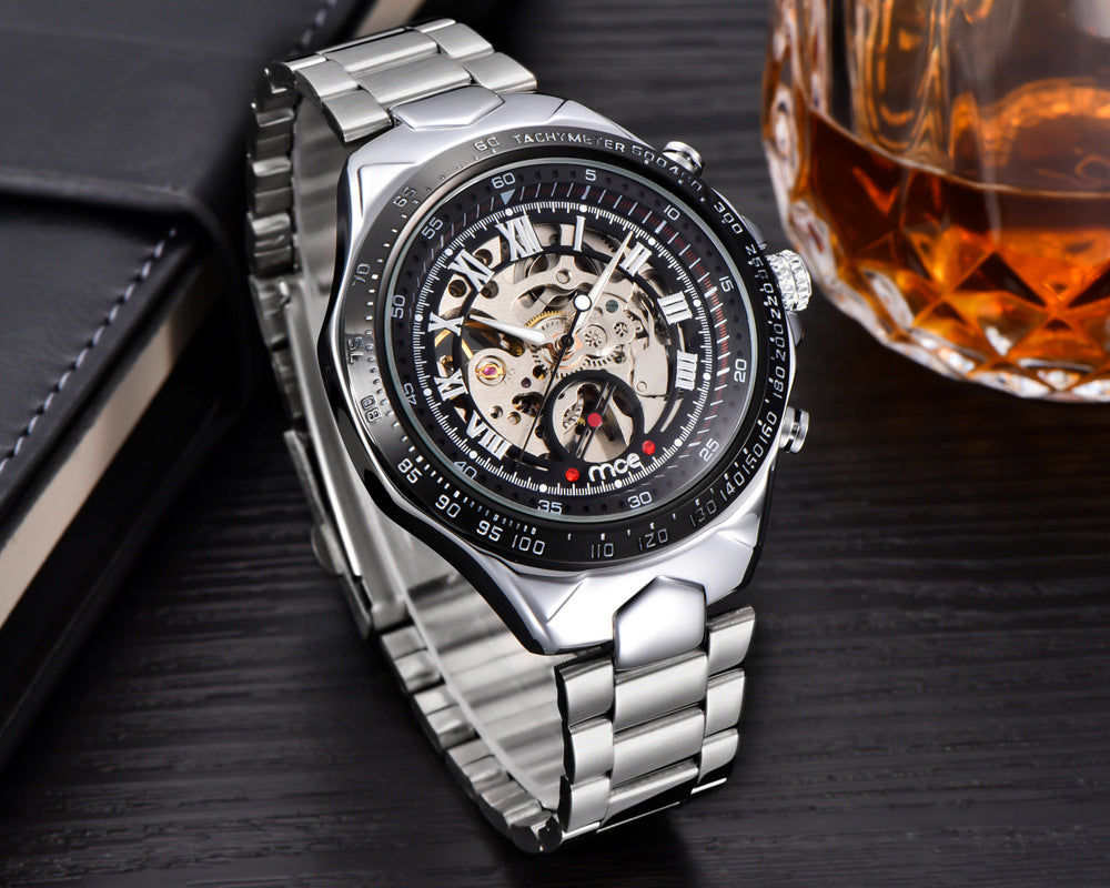 Silver mens mechanical watch with a detailed face on a dark surface