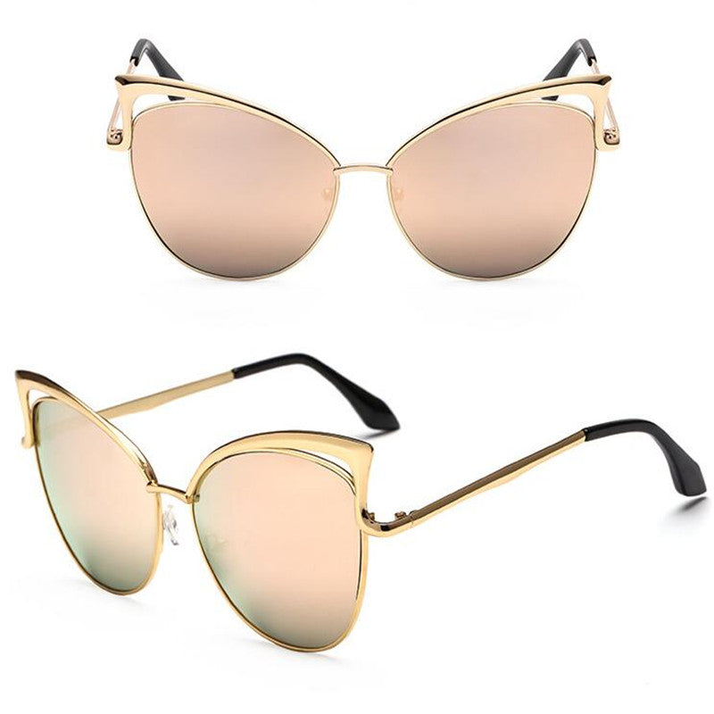 Gold-framed sunglasses with reflective lenses on a white background