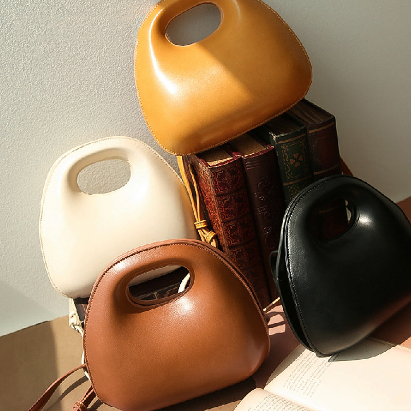 Four leather messenger bags in different colors