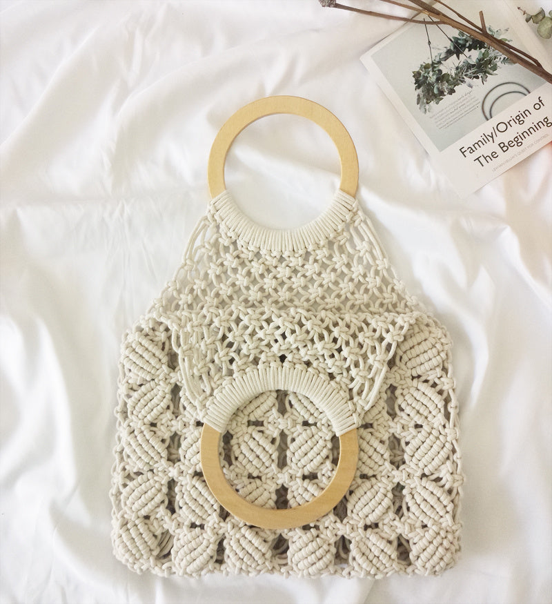 Macrame handbag with wooden handles on a white surface