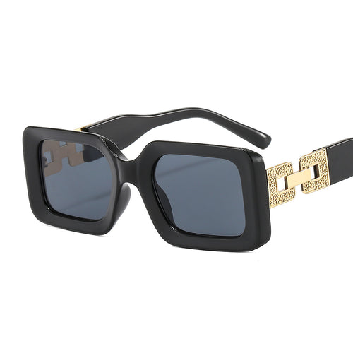 Black sunglasses with gold chain strap on a white background
