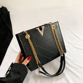 Black women's leather crossbody bag with gold chain strap