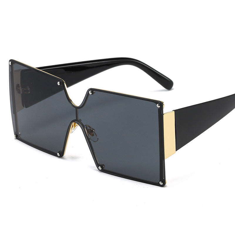 Black and gold sunglasses with a white background
