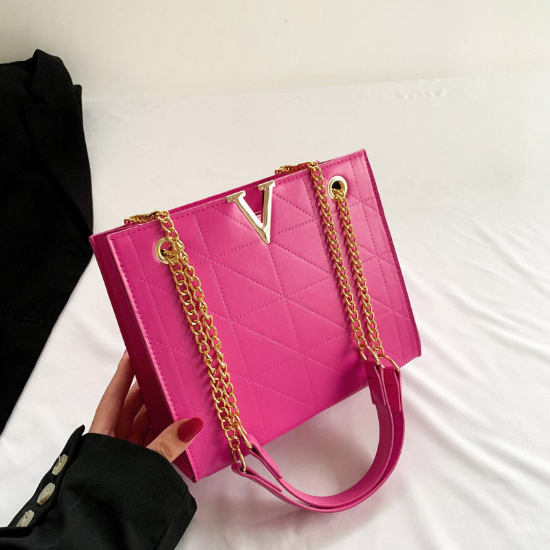 Pink women's leather crossbody bag with gold chain strap
