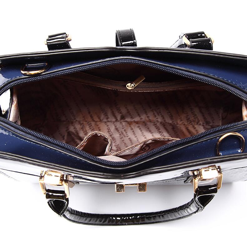 Close-up of a blue crocodile pattern handbag with gold accents