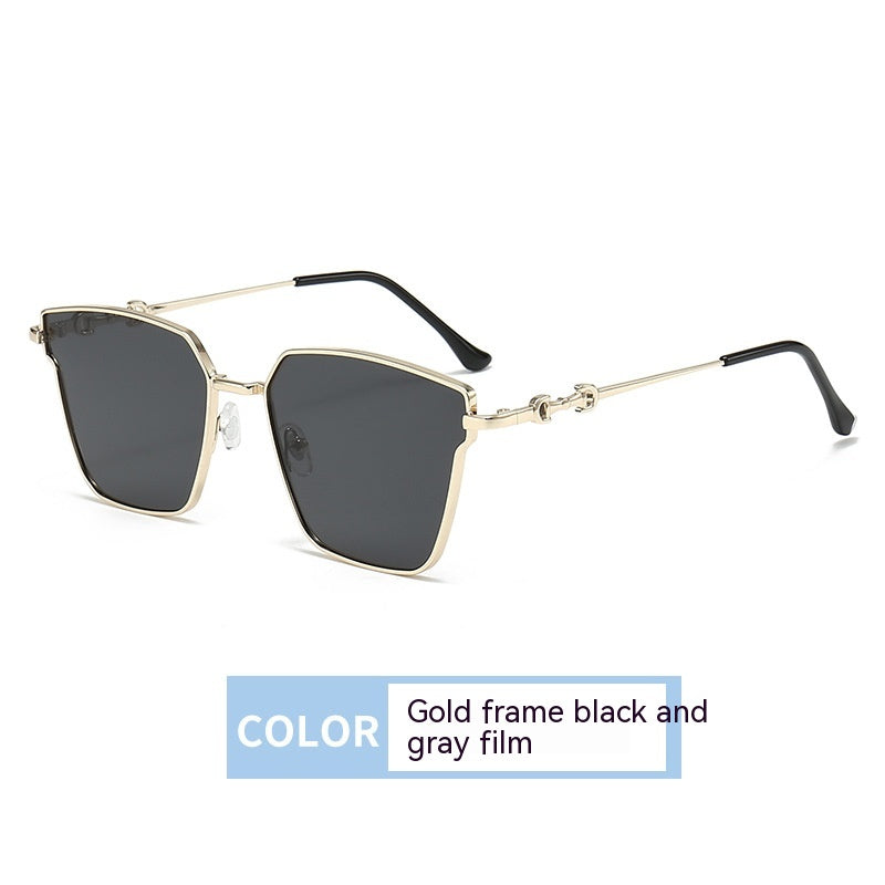 Sunglasses with gold frame and black and gray film on a white background
