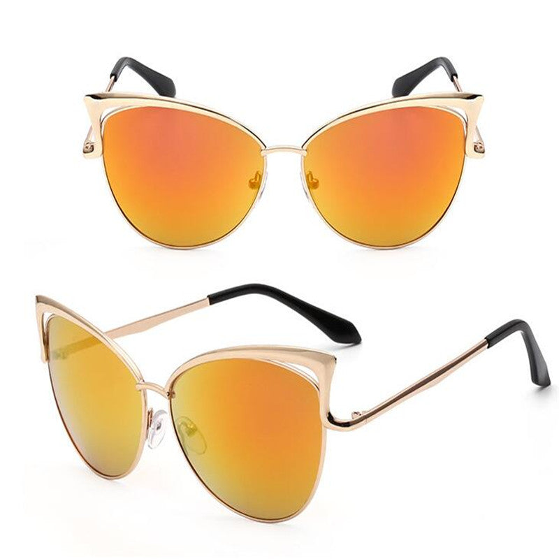 Cat-eye sunglasses with gold frames and orange lenses on a white background