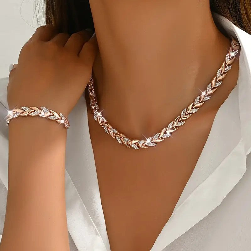 Rose gold braided leaf necklace and bracelet on a person