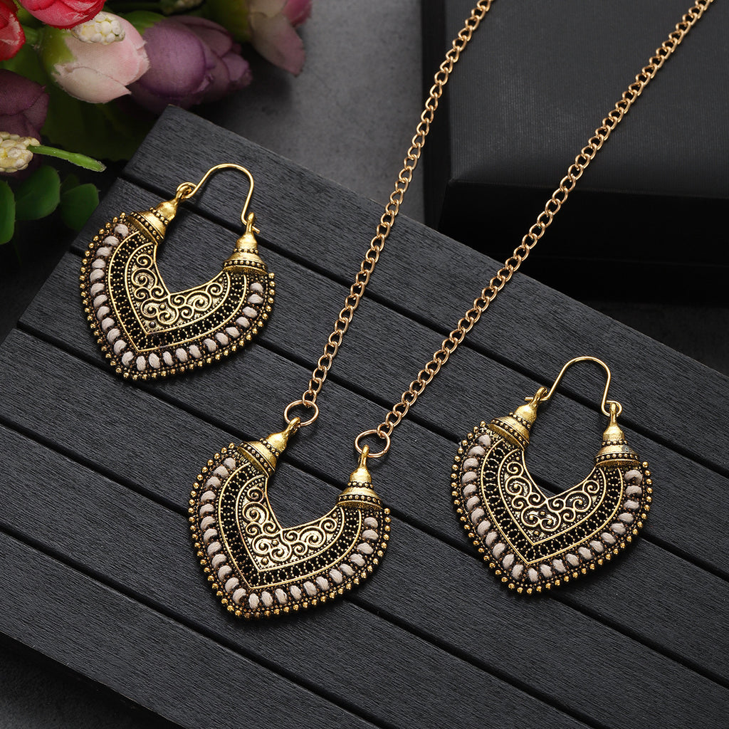 Gold jewelry set with heart-shaped necklace and earrings