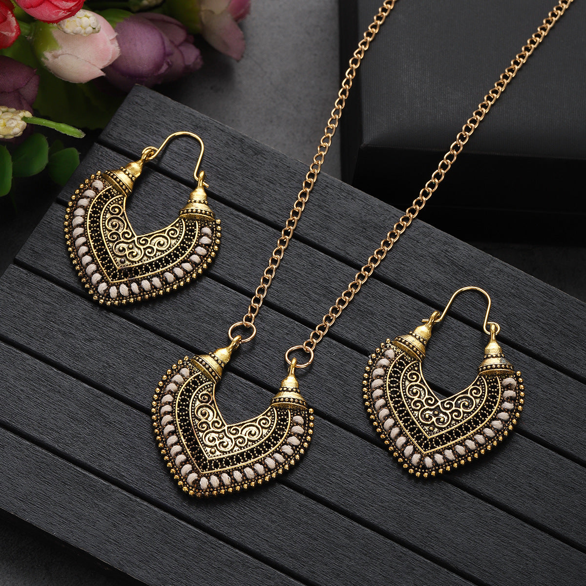Gold jewelry set with heart-shaped necklace and earrings