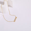Gold pendant necklace on a white background