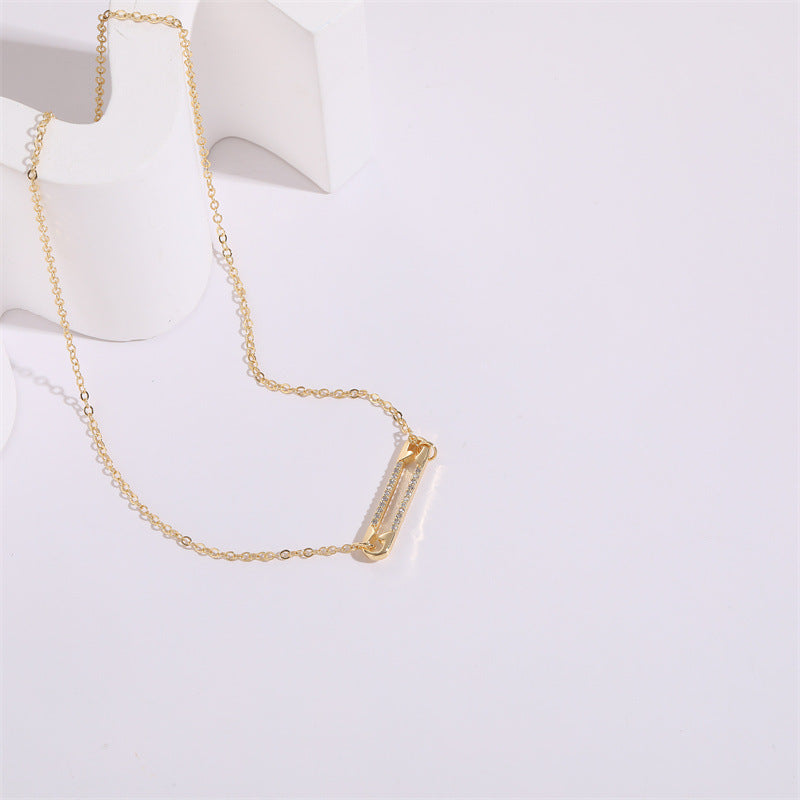 Gold pendant necklace on a white background