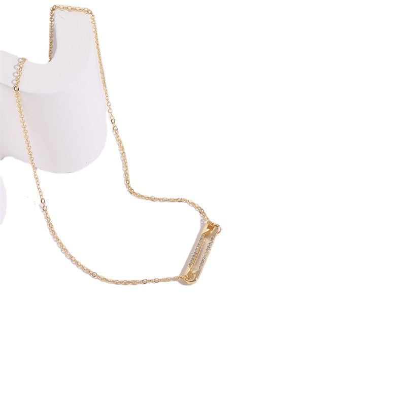 Gold pendant necklace with a white background