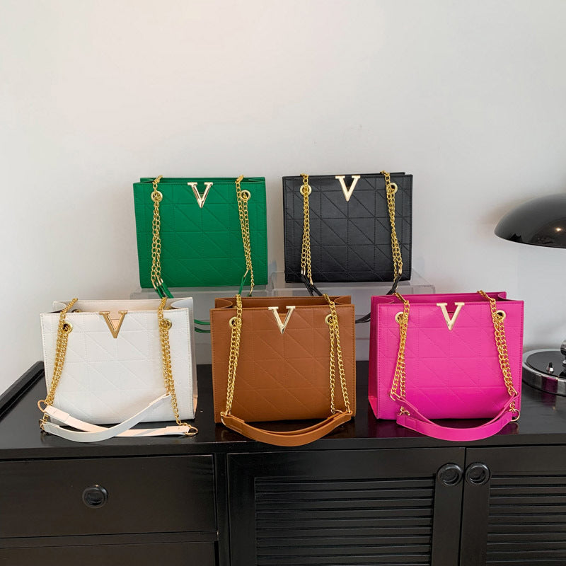Five colorful women's leather crossbody bags with gold chains