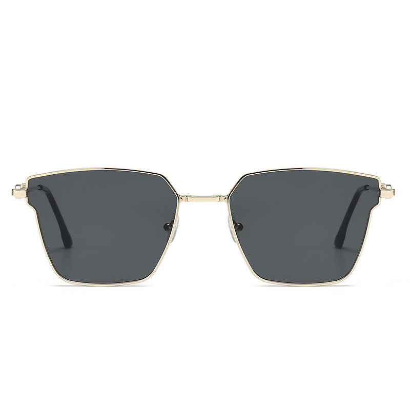 Sunglasses with gold frame and dark lenses on a white background