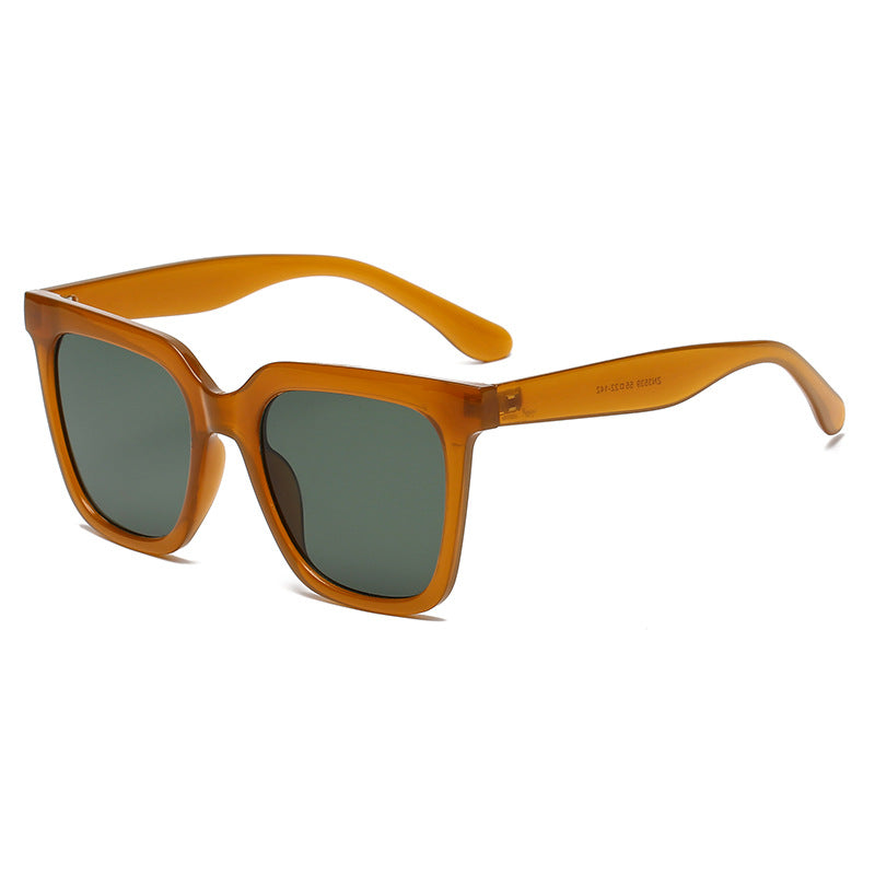 Sunglasses with orange frame and dark lenses on a white background