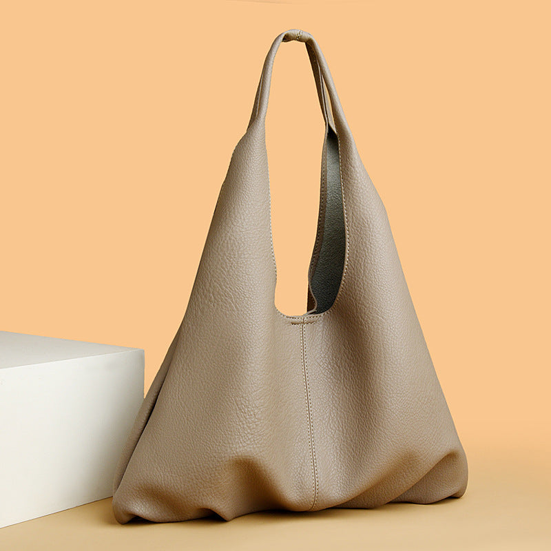 Beige underarm shoulder bag on a beige background