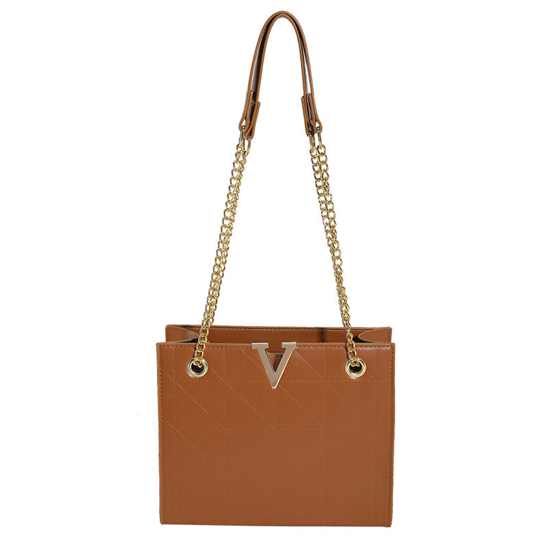 Brown women's leather crossbody bag with gold chain strap