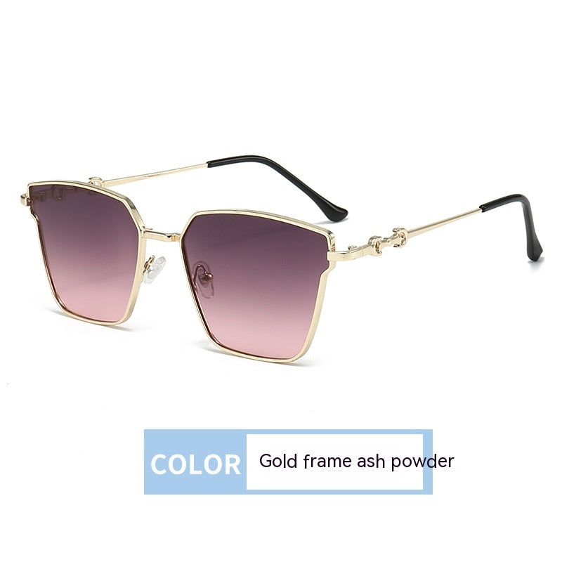Sunglasses with gold frame and ash powder lenses on a white background
