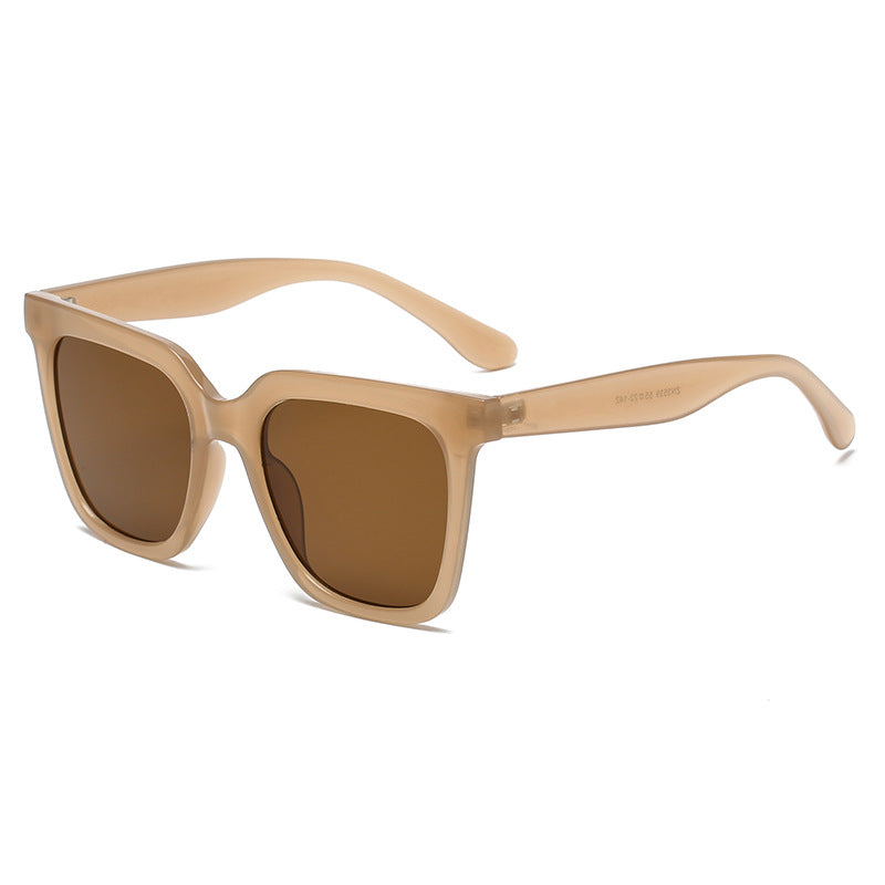 Beige sunglasses with brown lenses on a white background