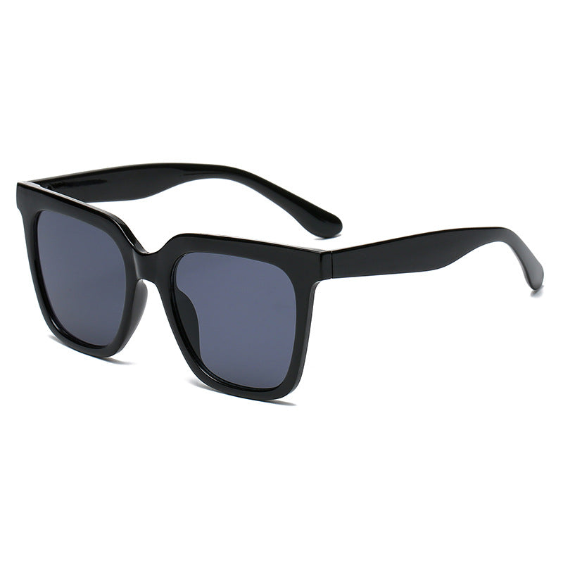 Black sunglasses with dark lenses on a white background