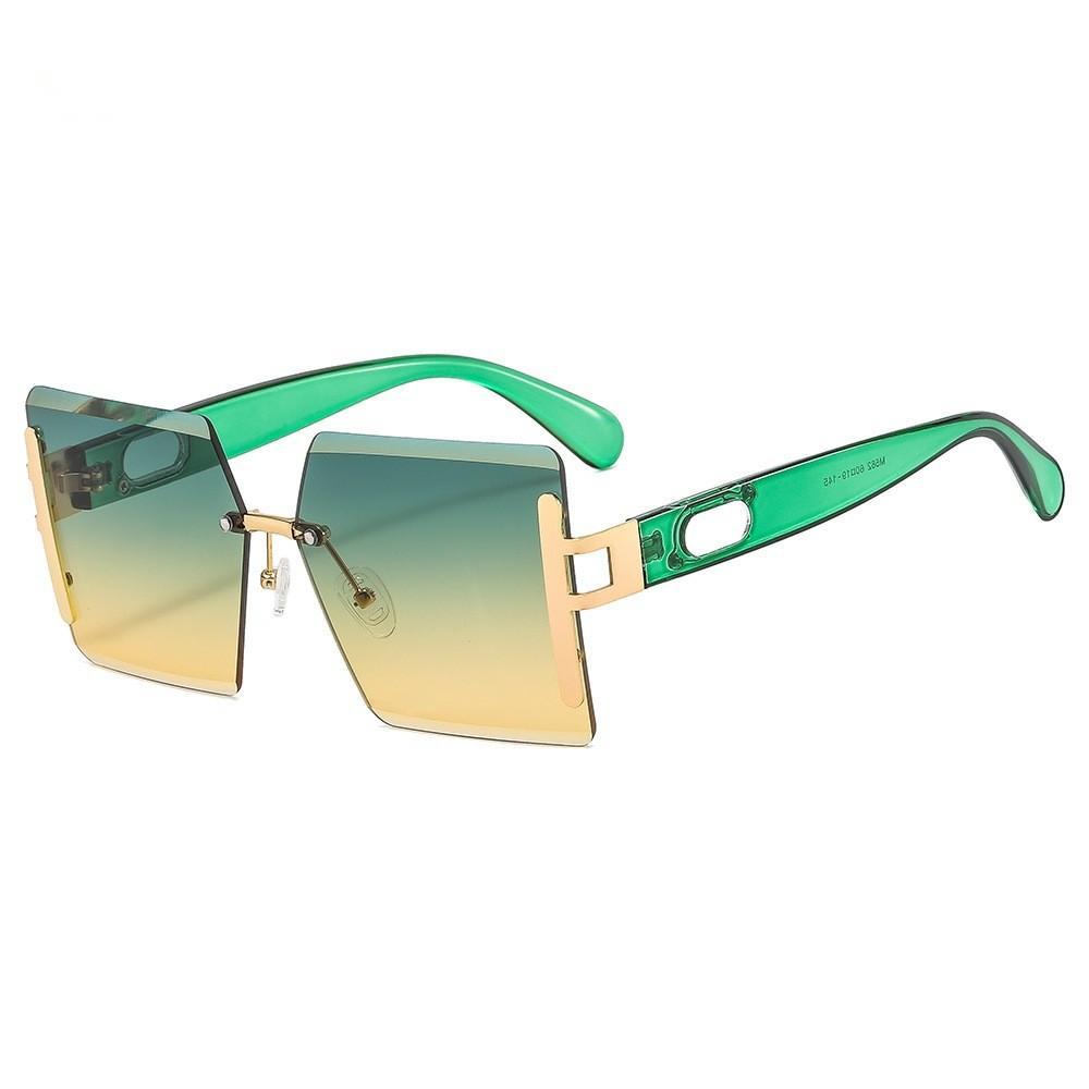 Sunglasses with green and gold gradient lenses on a white background