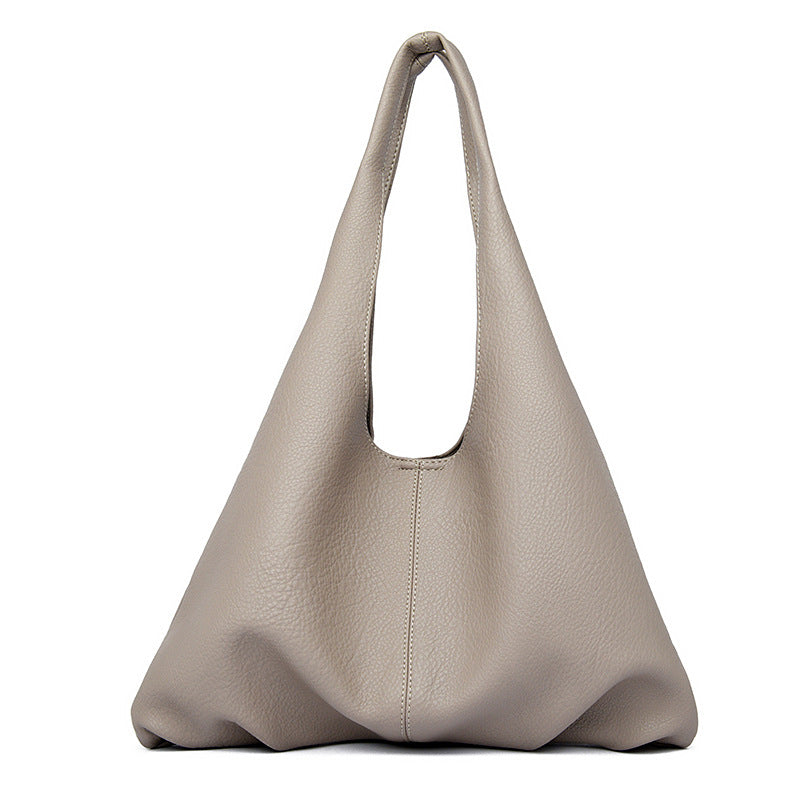 Beige underarm shoulder bag on a white background