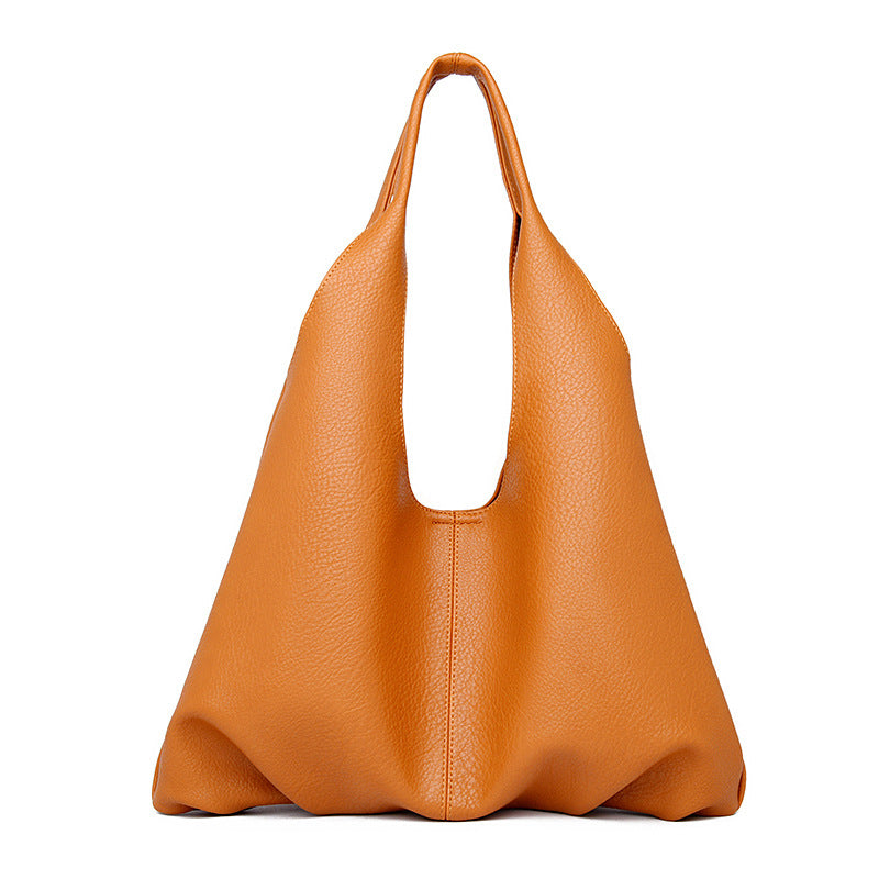 Orange leather underarm shoulder bag on a white background