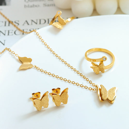 Gold butterfly jewelry set including necklace, butterfly earrings, and ring
