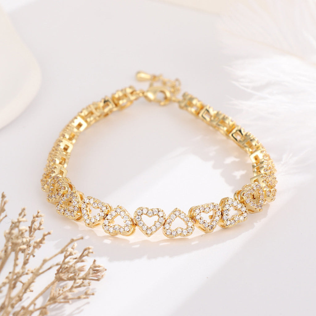 Gold heart bracelet on a white background